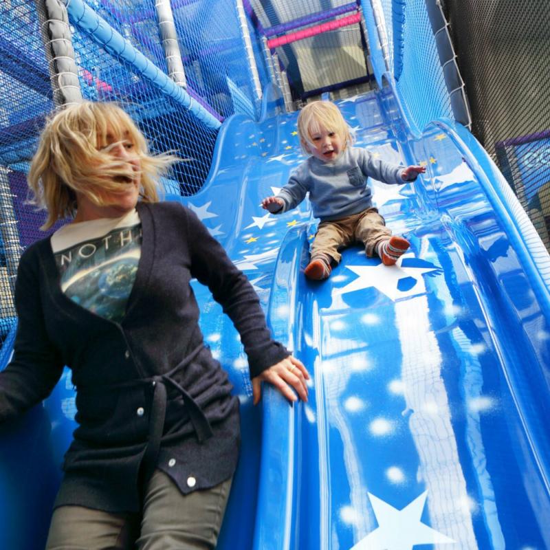 mother and child having fun on slide at the Milky Way